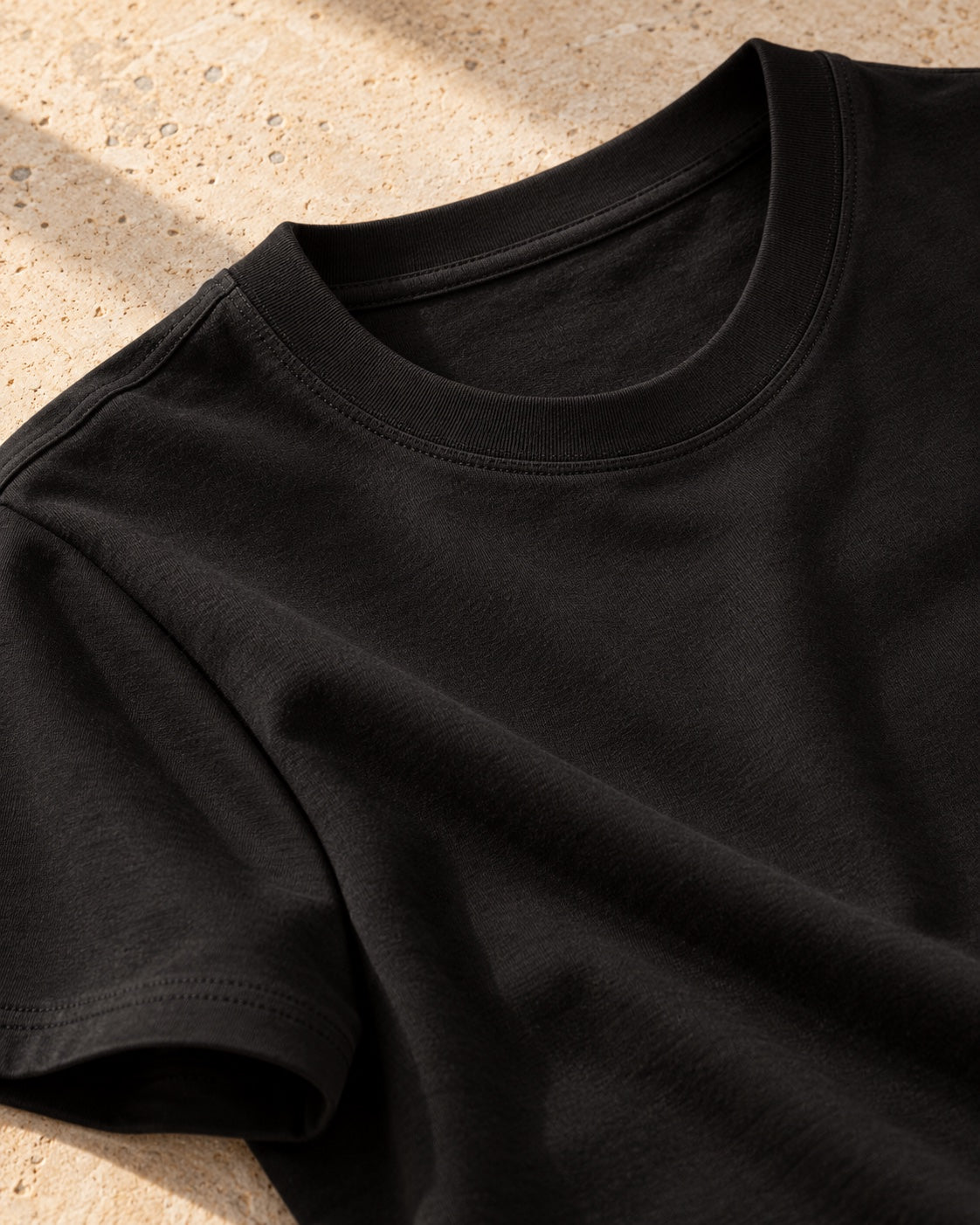 The smooth crew neckline and clean shoulder stitching of the Iconic.